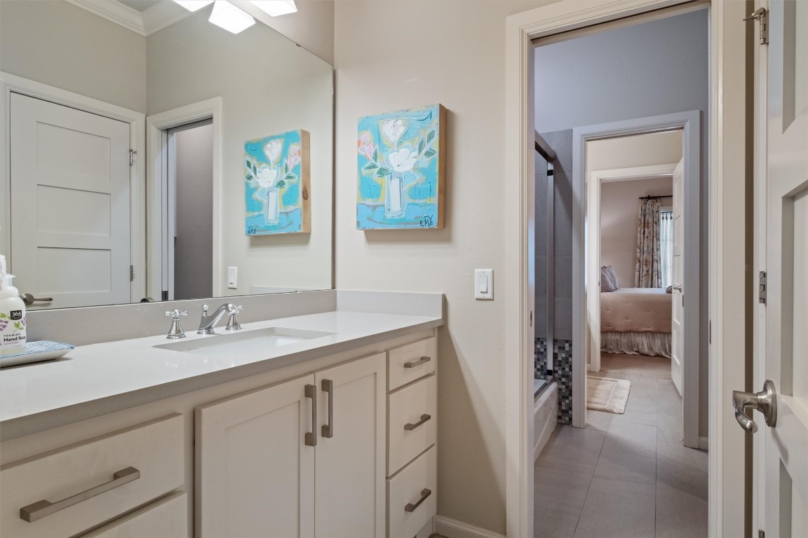 1200 Marlboro Lane, Nichols Hills, OK 73116 bathroom featuring tile flooring, vanity, and ornamental molding