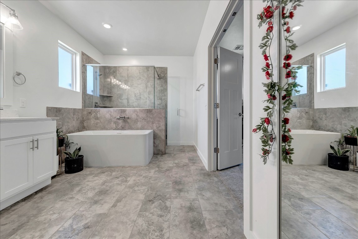 2140 Santa Monica Street, Edmond, OK 73034 bathroom featuring a healthy amount of sunlight, vanity, and tile flooring