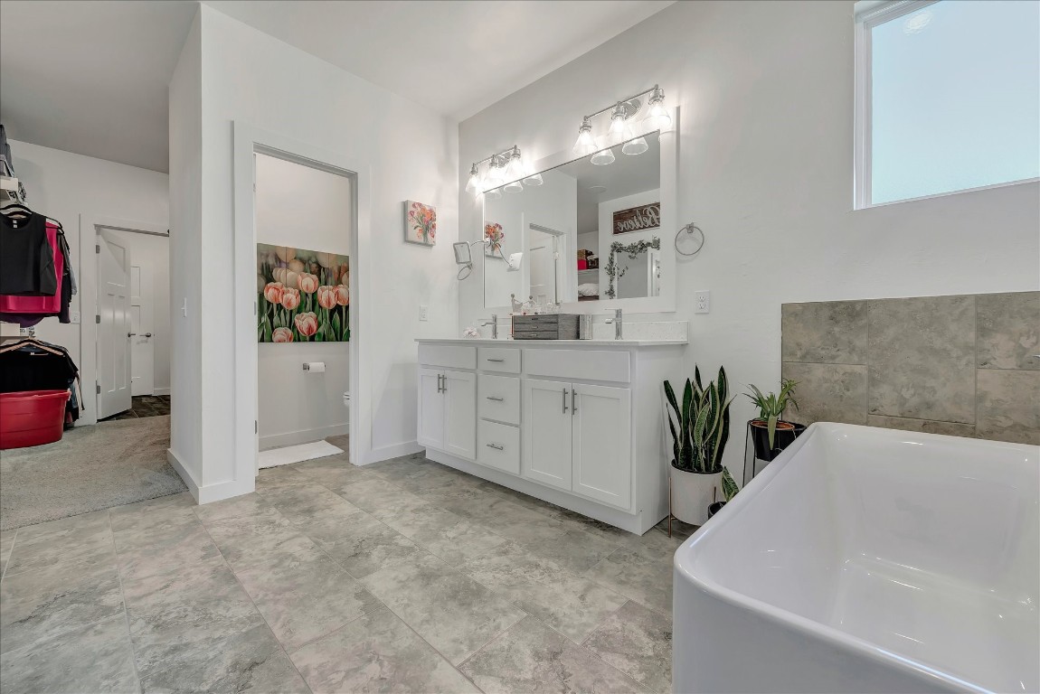 2140 Santa Monica Street, Edmond, OK 73034 bathroom with vanity, a bath, and tile flooring