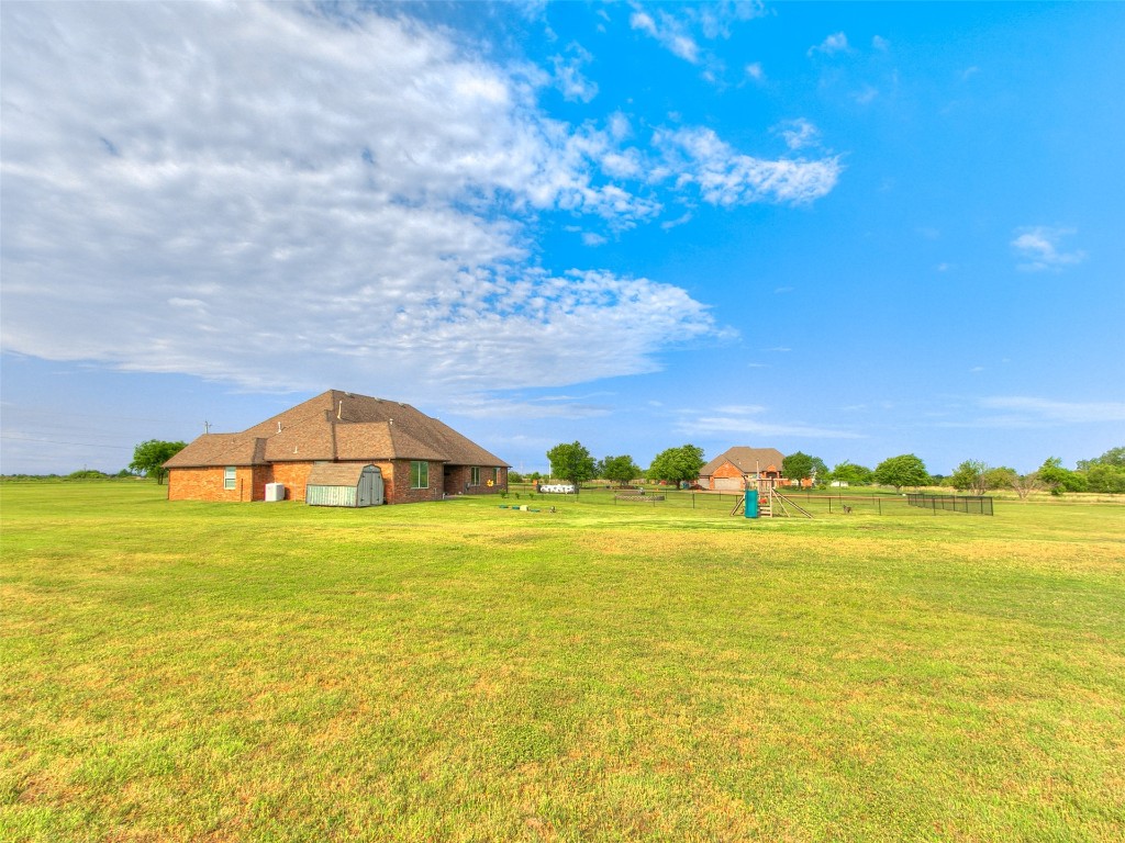 2900 Big Sky Circle, Yukon, OK 73099 view of yard with an outdoor structure, a rural view, and a playground