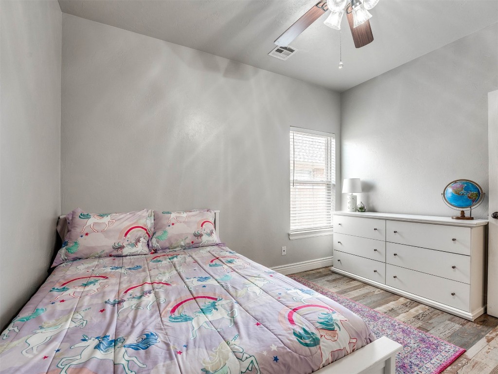 5112 SW 123rd Street, Oklahoma City, OK 73173 bedroom with hardwood / wood-style floors and ceiling fan