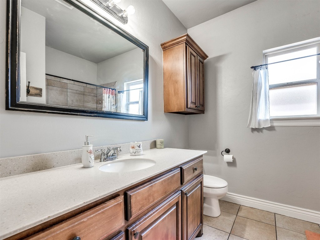 5112 SW 123rd Street, Oklahoma City, OK 73173 bathroom featuring vanity, tile floors, and toilet