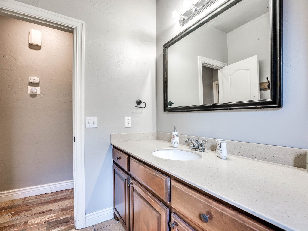 5112 SW 123rd Street, Oklahoma City, OK 73173 bathroom featuring hardwood / wood-style floors and vanity