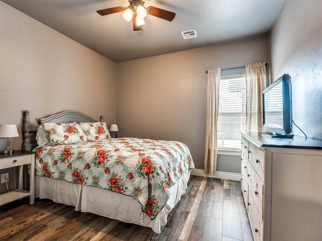 5112 SW 123rd Street, Oklahoma City, OK 73173 bedroom featuring ceiling fan and dark hardwood / wood-style floors