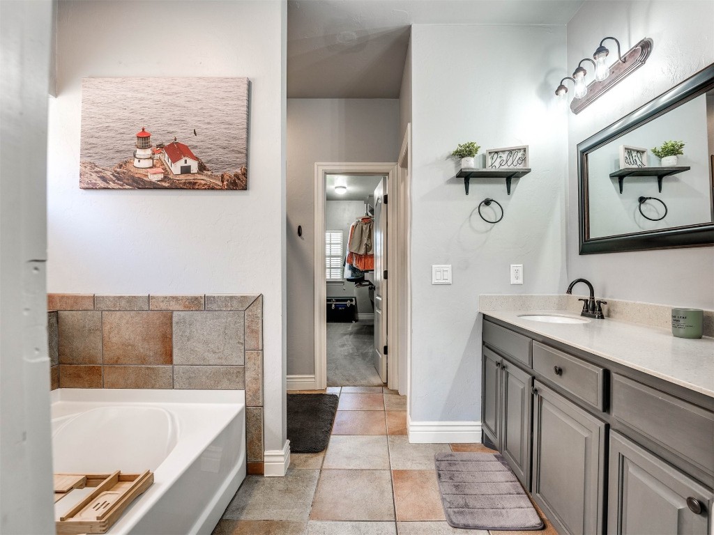 5112 SW 123rd Street, Oklahoma City, OK 73173 bathroom featuring a bathtub, vanity, and tile flooring