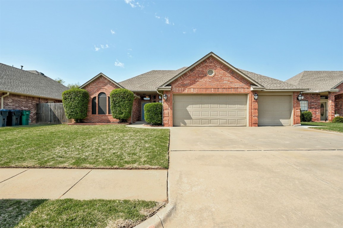 10609 NW 37th Street, Yukon, OK 73099 single story home featuring a front yard and a garage