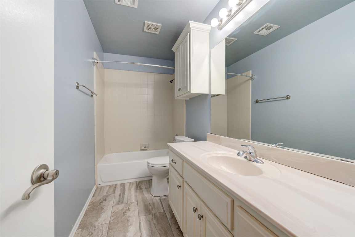 10609 NW 37th Street, Yukon, OK 73099 full bathroom with shower / tub combination, oversized vanity, and toilet