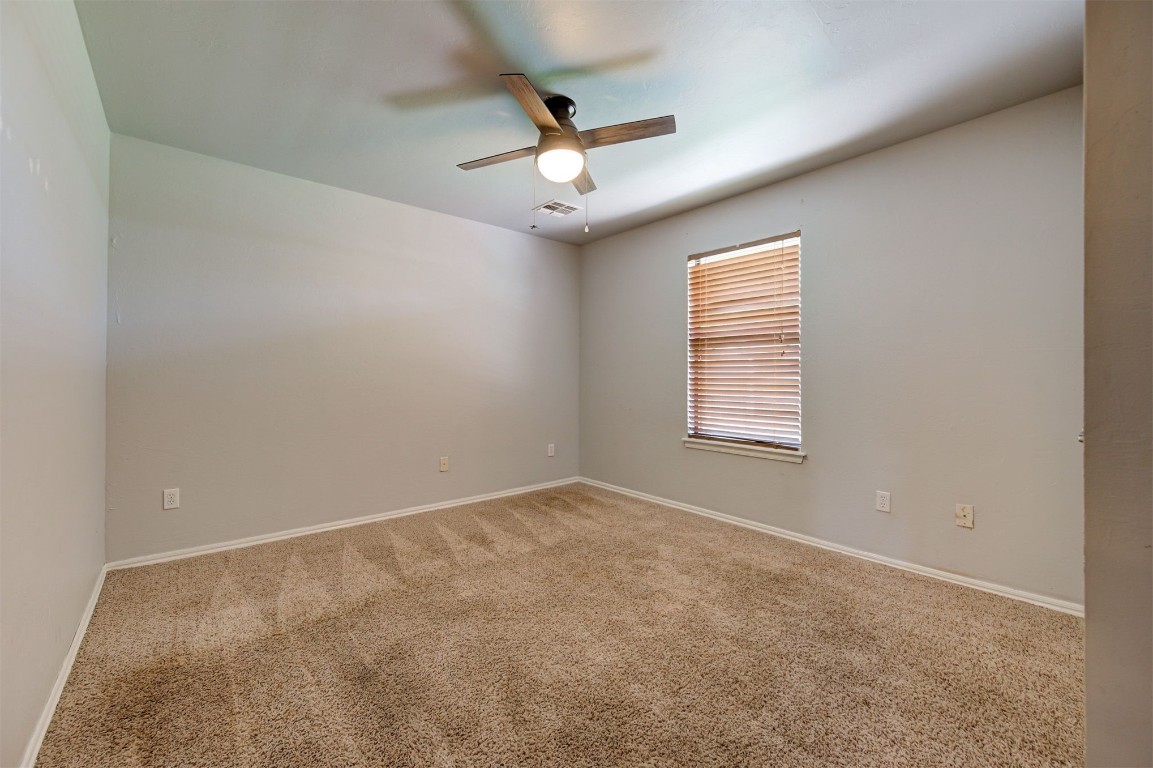 10609 NW 37th Street, Yukon, OK 73099 carpeted empty room featuring ceiling fan
