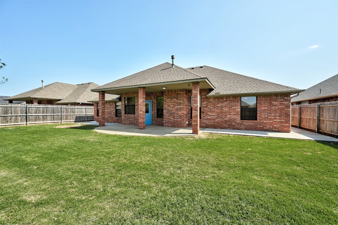 10609 NW 37th Street, Yukon, OK 73099 rear view of house featuring a patio area and a yard