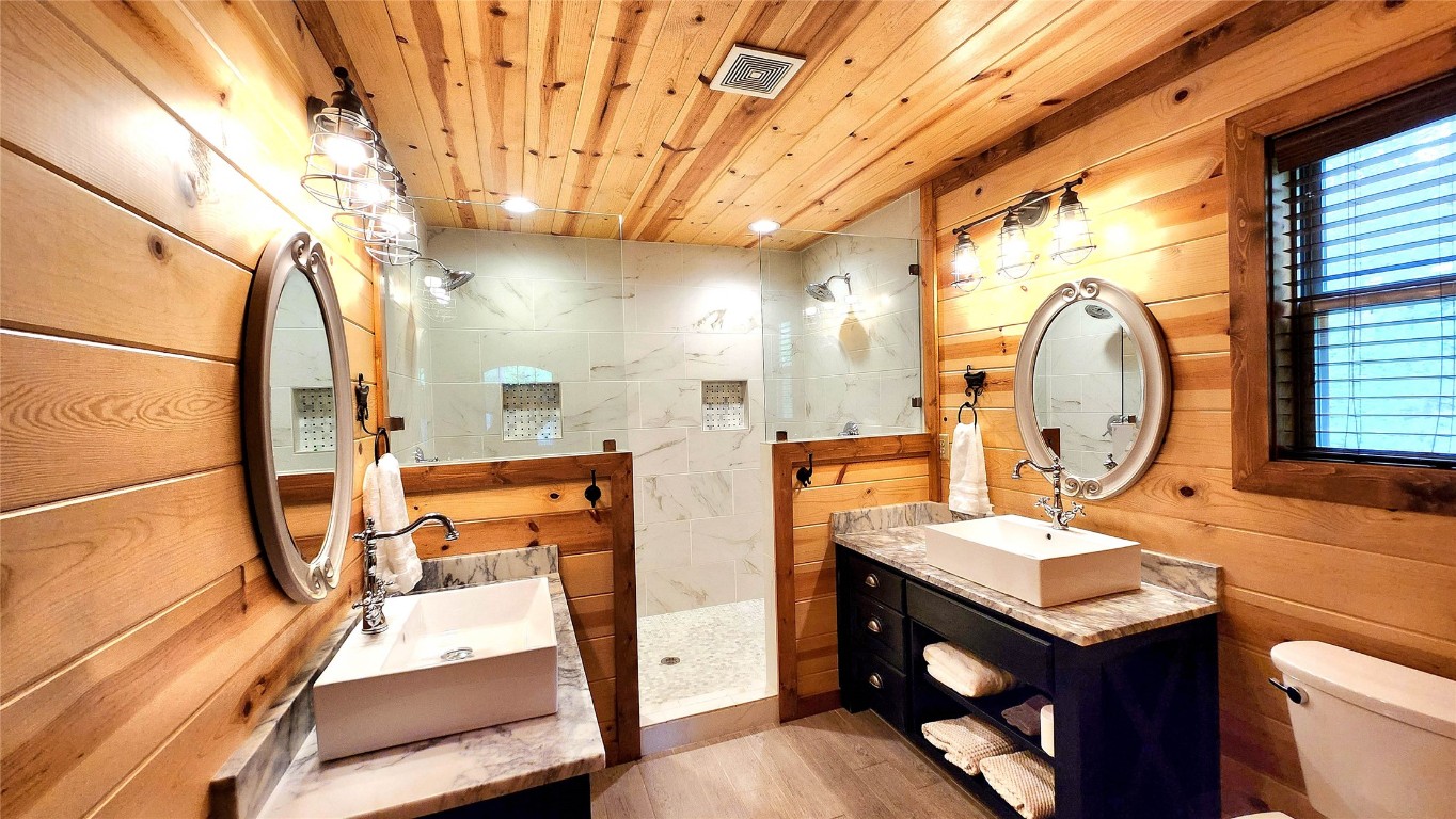 57 Mayflower Circle, Broken Bow, OK 74728 bathroom featuring wooden walls, toilet, wooden ceiling, vanity, and hardwood / wood-style flooring
