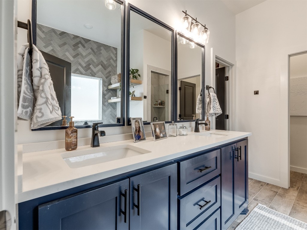 2300 El Cajon Street, Edmond, OK 73034 bathroom featuring dual bowl vanity and hardwood / wood-style flooring