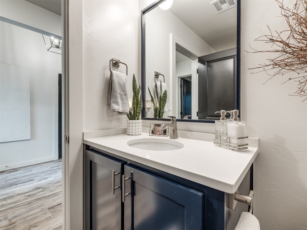 2300 El Cajon Street, Edmond, OK 73034 bathroom with wood-type flooring and vanity
