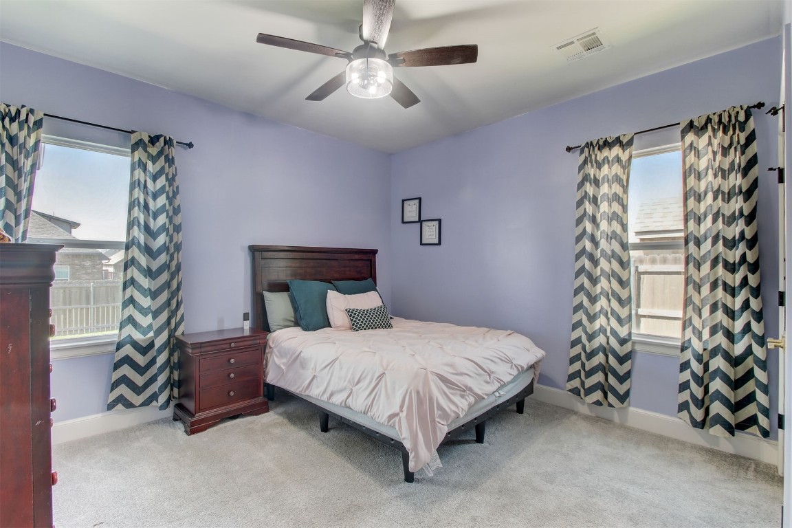 9224 NW 82nd Street, Yukon, OK 73099 carpeted bedroom featuring ceiling fan