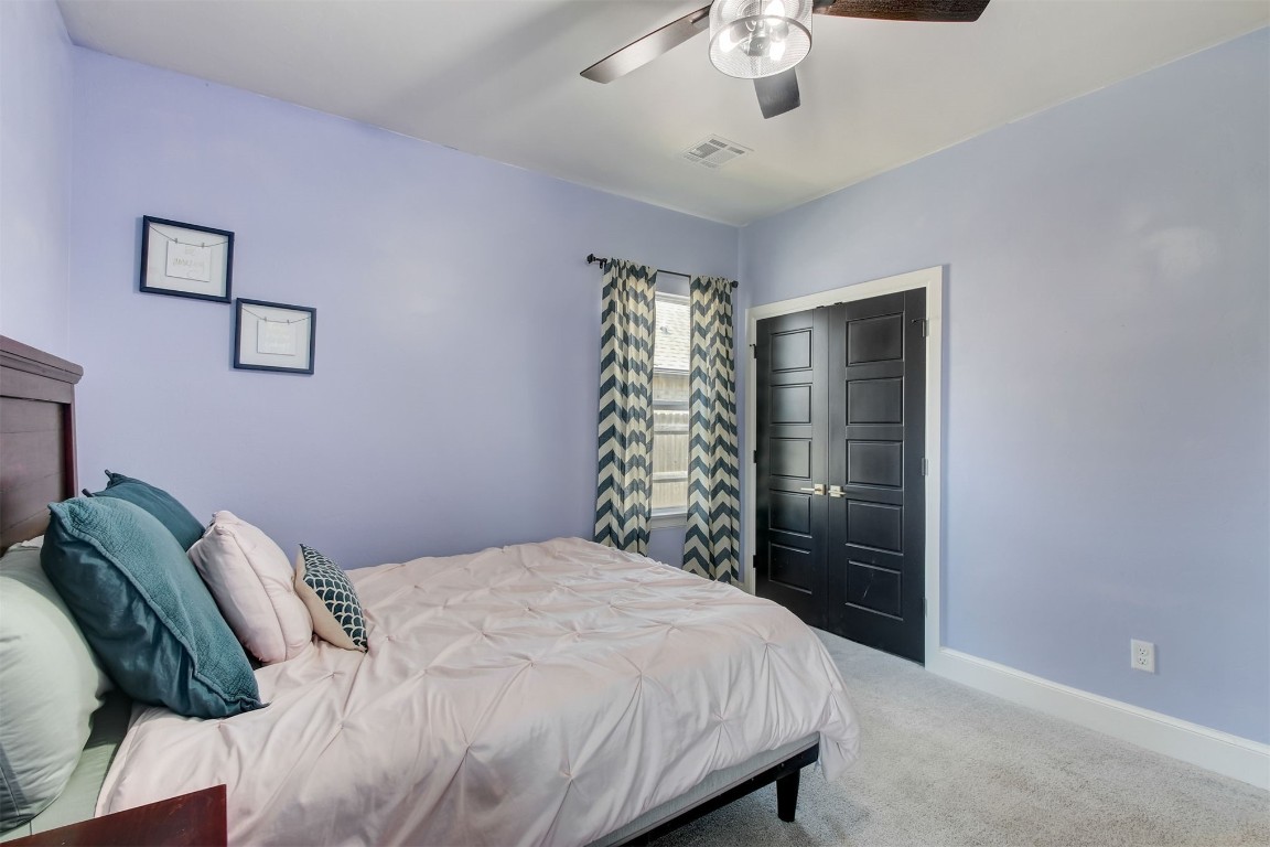9224 NW 82nd Street, Yukon, OK 73099 bedroom featuring a closet, ceiling fan, and carpet floors