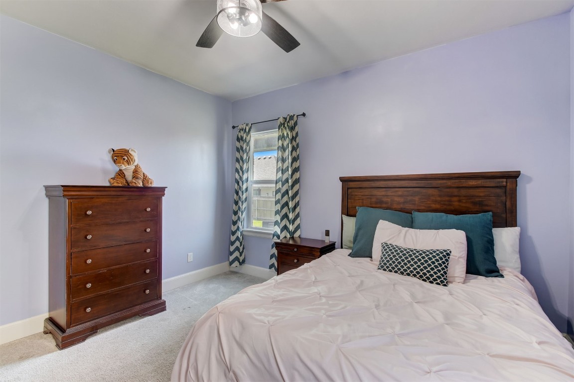 9224 NW 82nd Street, Yukon, OK 73099 carpeted bedroom with ceiling fan