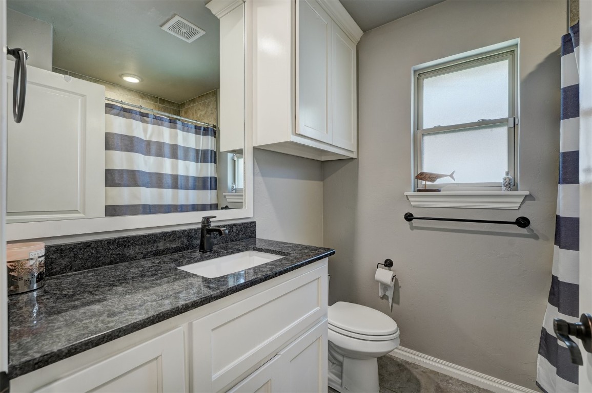 18700 Lazy Grove Drive, Edmond, OK 73012 bathroom with toilet, tile flooring, and vanity