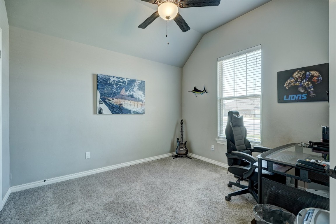 18700 Lazy Grove Drive, Edmond, OK 73012 carpeted office with ceiling fan and vaulted ceiling