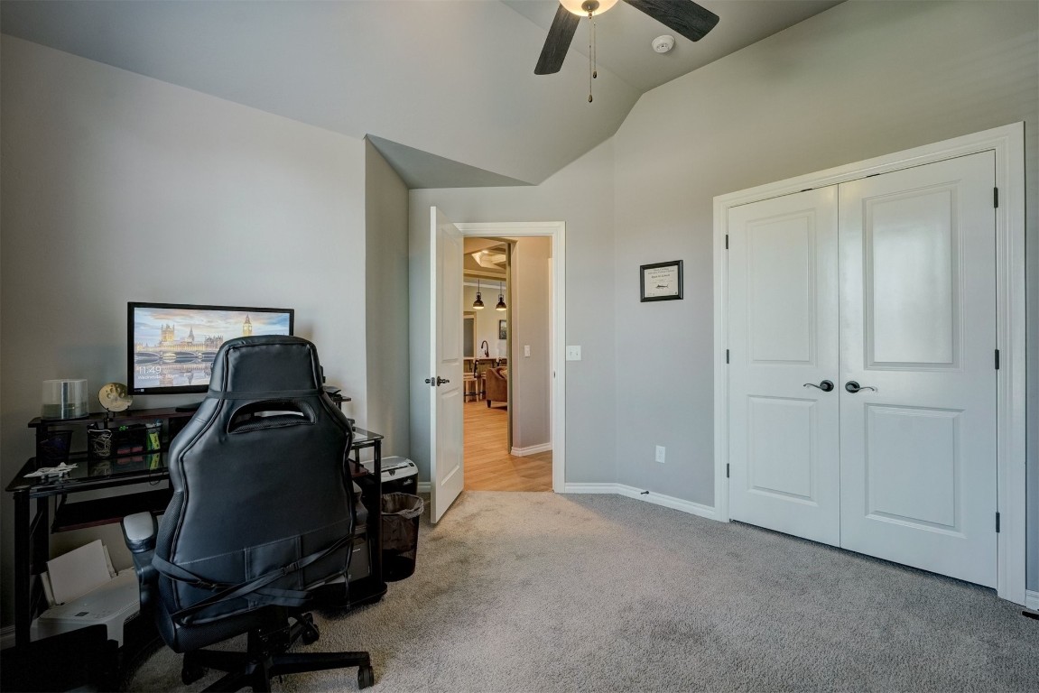 18700 Lazy Grove Drive, Edmond, OK 73012 office space featuring carpet, ceiling fan, and vaulted ceiling