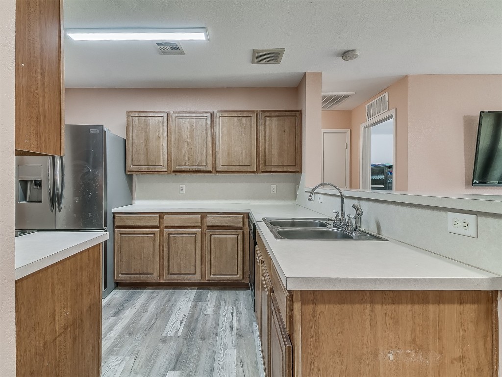 15509 Ivy Hill Drive, Oklahoma City, OK 73170 kitchen with sink, light hardwood / wood-style floors, and kitchen peninsula