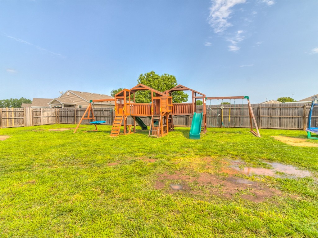 15509 Ivy Hill Drive, Oklahoma City, OK 73170 view of yard featuring a playground and a trampoline