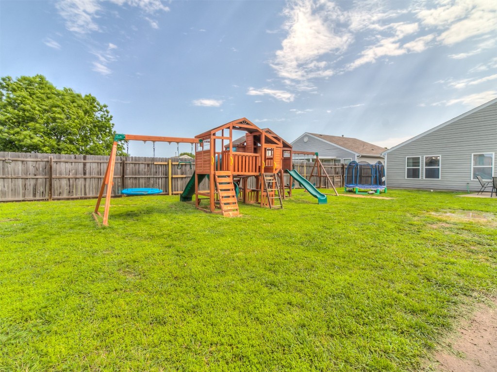 15509 Ivy Hill Drive, Oklahoma City, OK 73170 view of yard with a playground and a trampoline