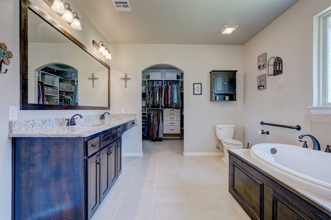551 Canyon Creek Lane, Guthrie, OK 73044 bathroom with toilet, tile flooring, vanity, and a bath