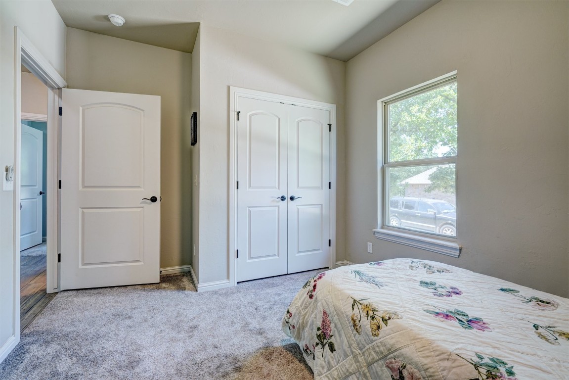 551 Canyon Creek Lane, Guthrie, OK 73044 carpeted bedroom featuring a closet