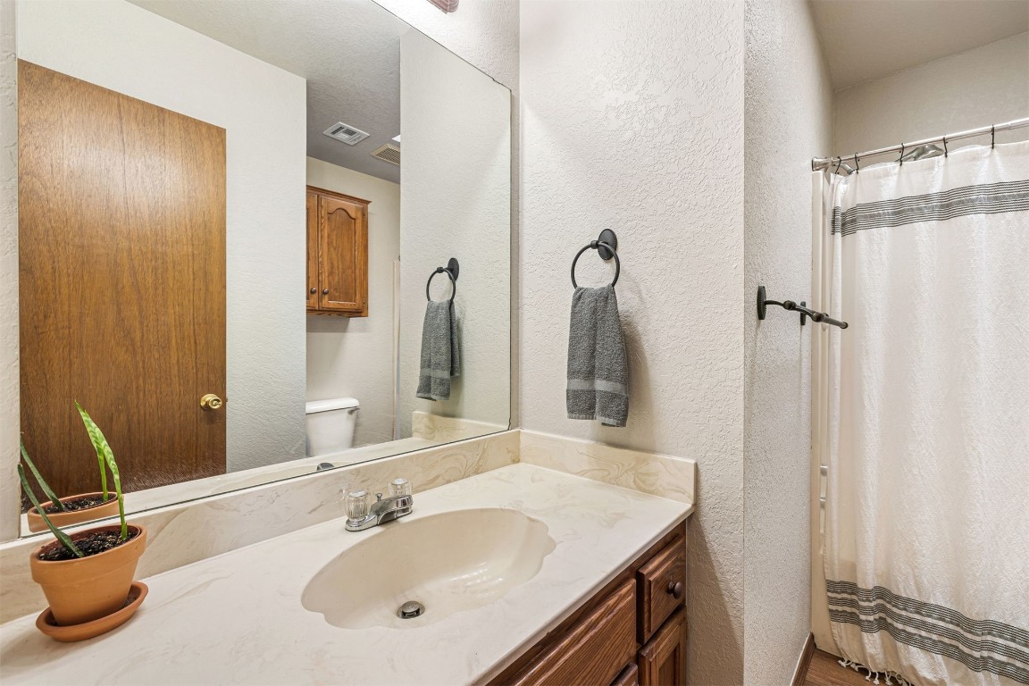 1007 SW 23rd Street, Moore, OK 73170 bathroom featuring toilet and vanity