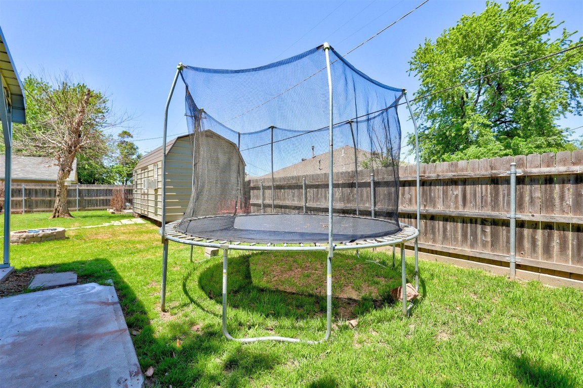 1008 Sunset Drive, El Reno, OK 73036 view of yard featuring a trampoline and a storage shed