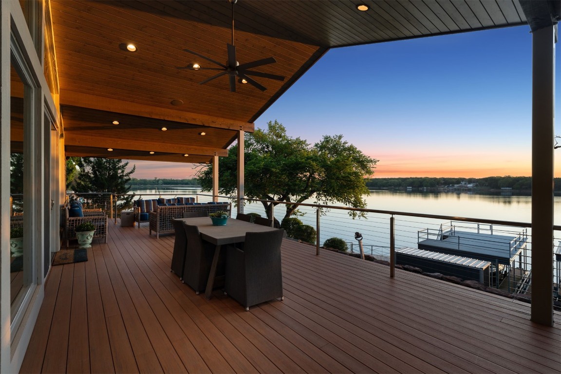103 E Shore Drive, Arcadia, OK 73007 deck at dusk with ceiling fan and a water view