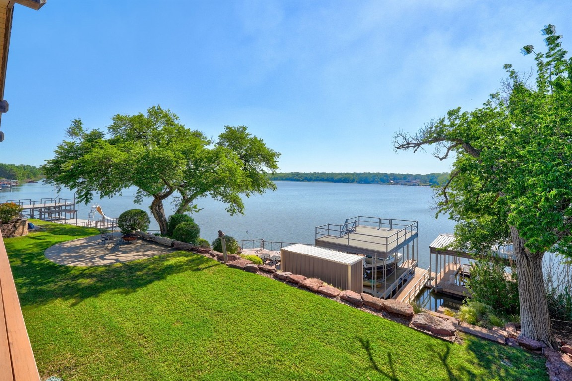 103 E Shore Drive, Arcadia, OK 73007 view of dock featuring a water view and a lawn