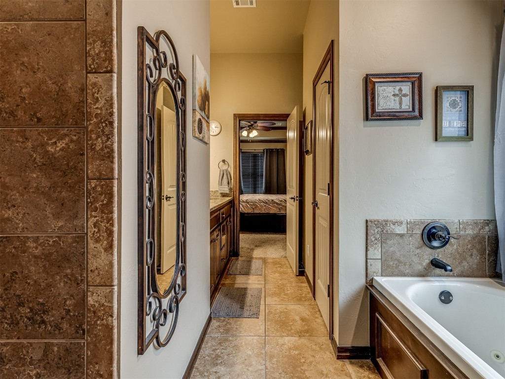 11816 SW 17th Street, Yukon, OK 73099 bathroom featuring a washtub, oversized vanity, and tile floors