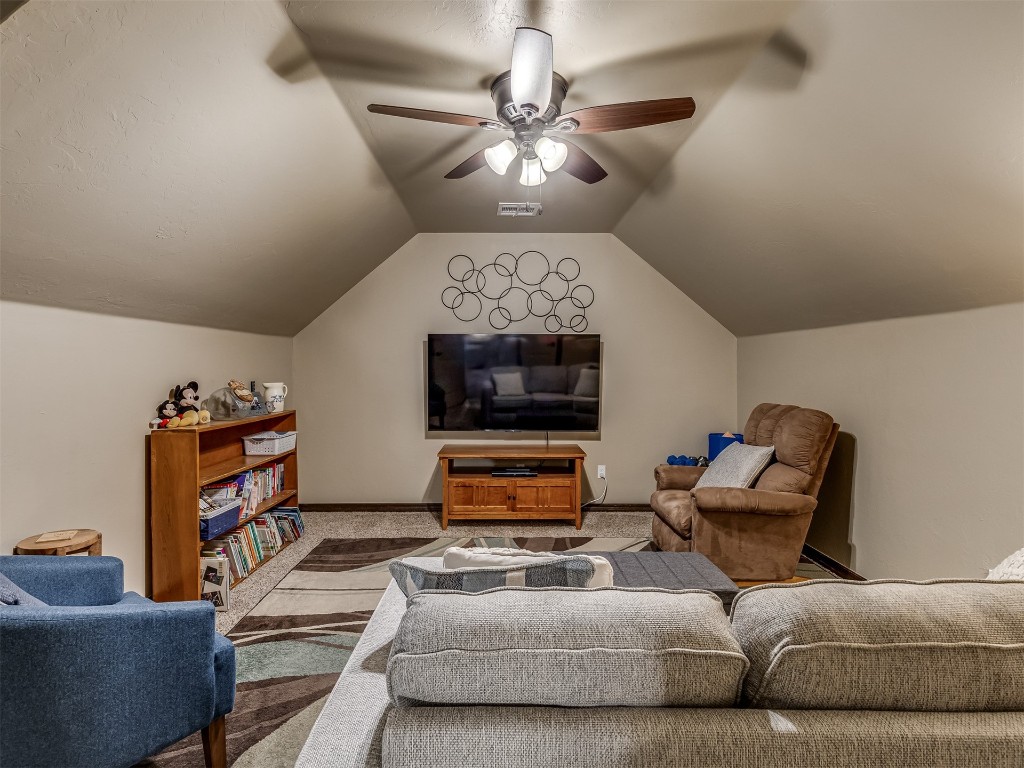 11816 SW 17th Street, Yukon, OK 73099 carpeted living room featuring lofted ceiling and ceiling fan