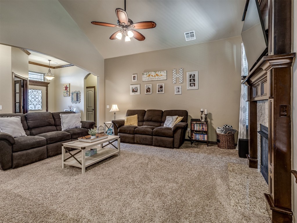 11816 SW 17th Street, Yukon, OK 73099 carpeted living room featuring a towering ceiling and ceiling fan