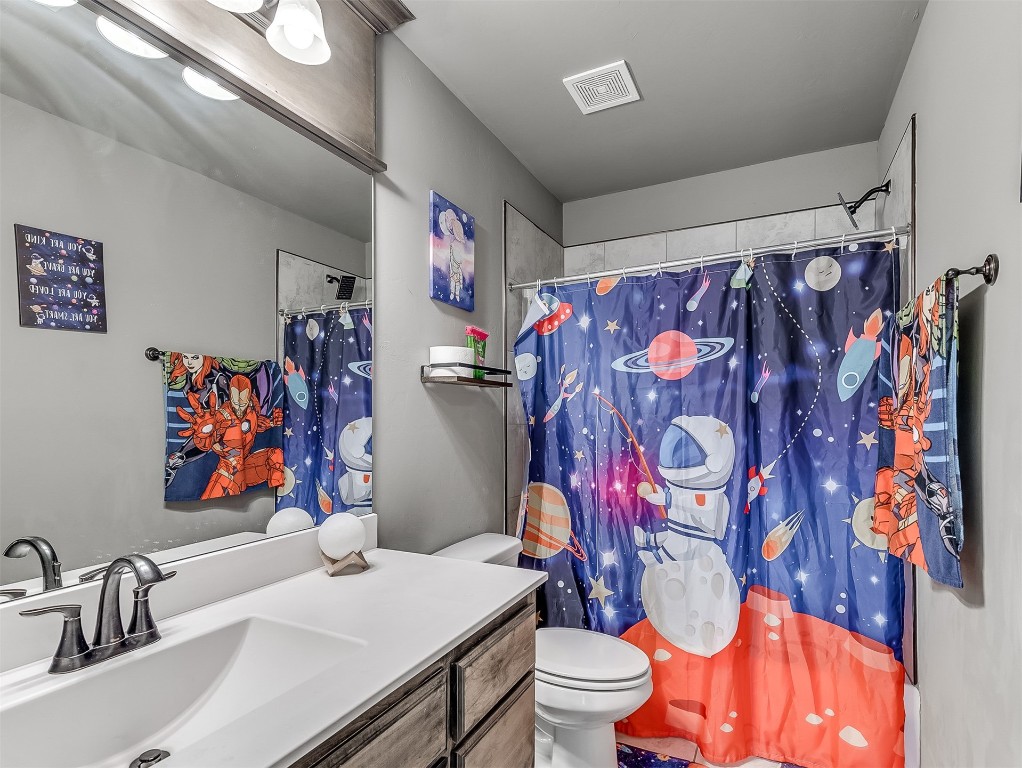 6716 NW 158th Street, Edmond, OK 73013 bathroom featuring toilet and vanity