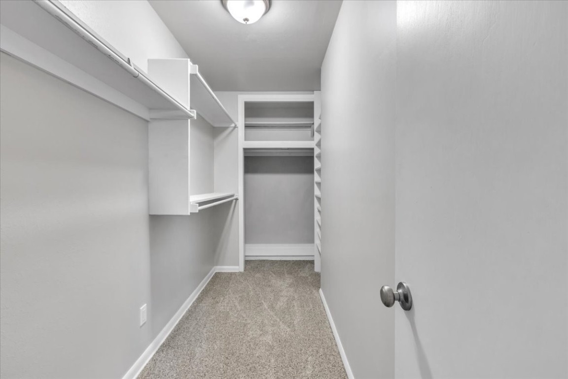 5712 N Roff Avenue, Oklahoma City, OK 73112 walk in closet featuring light carpet