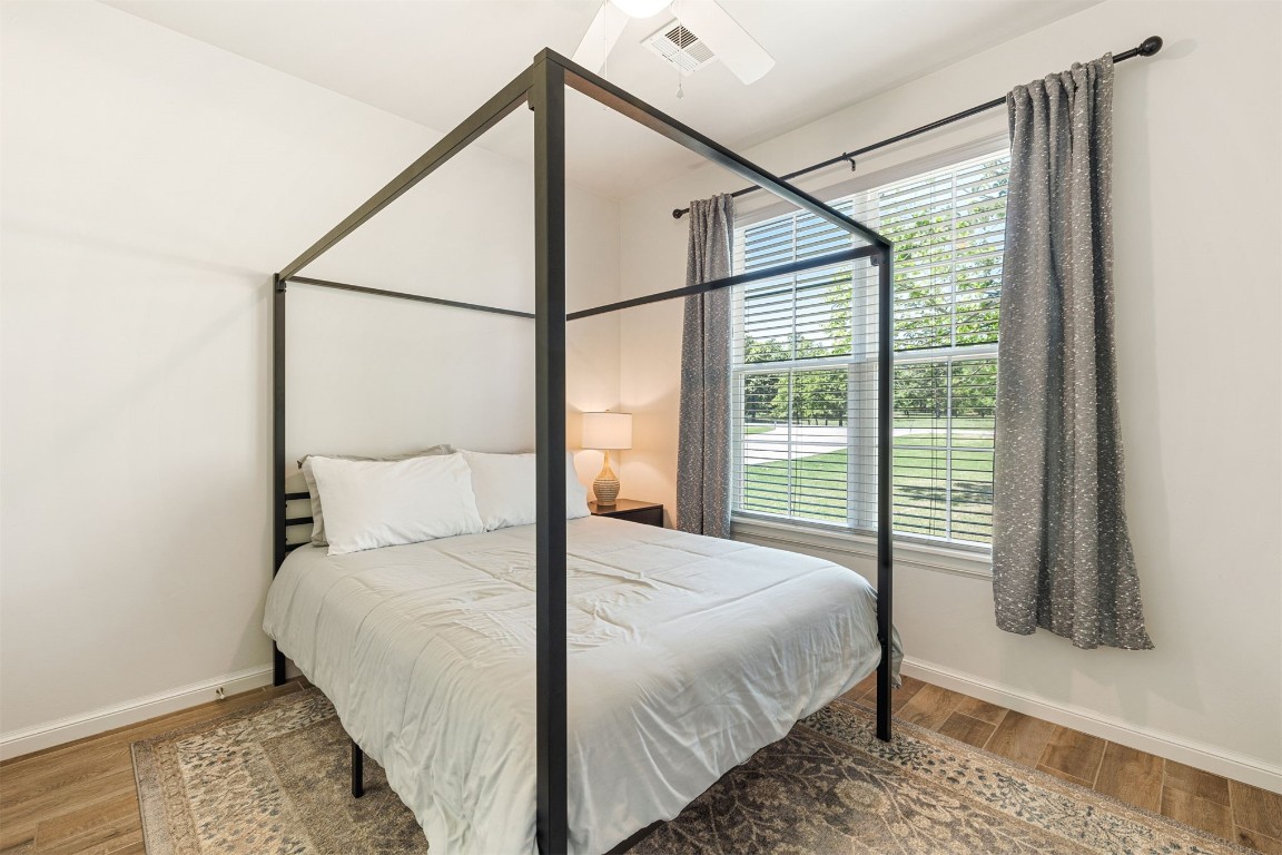 32704 Tincup Drive, Shawnee, OK 74804 bedroom with hardwood / wood-style flooring