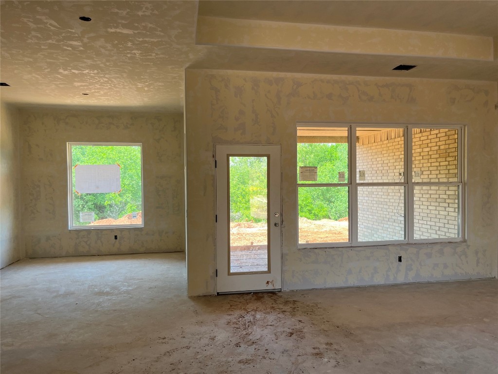 10305 Two Lakes Drive, Yukon, OK 73099 empty room with concrete flooring and a textured ceiling