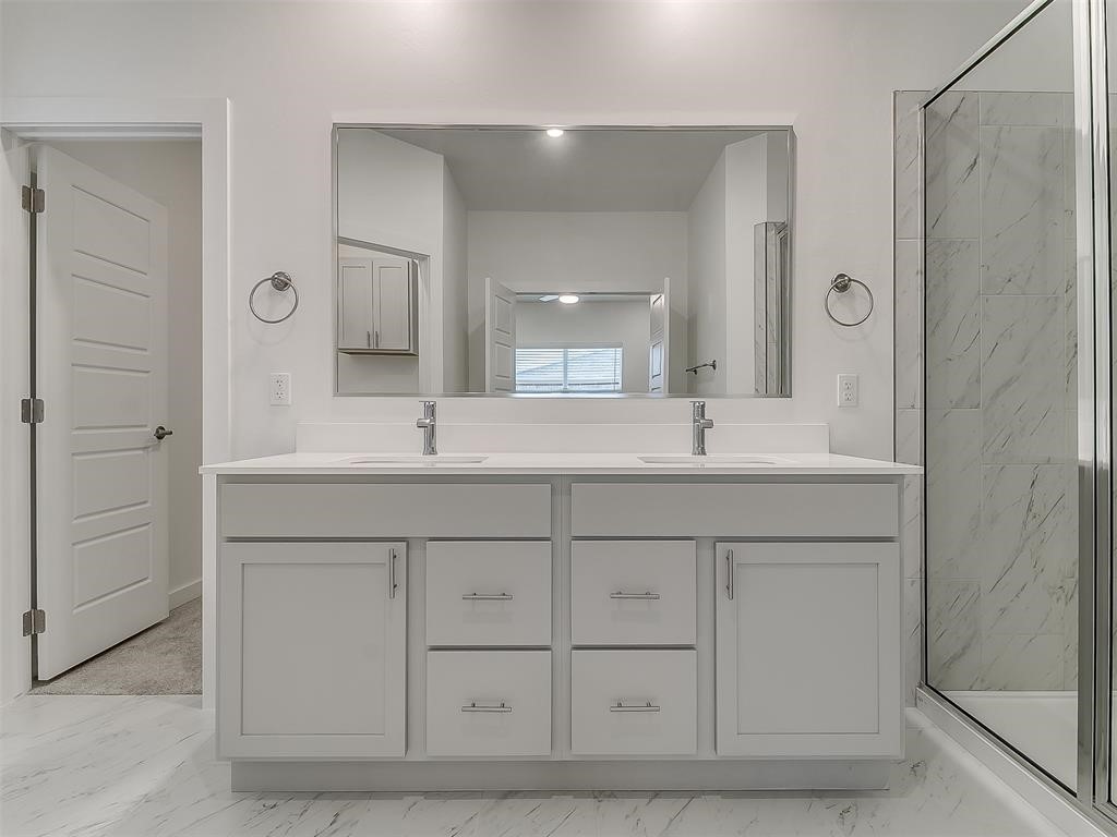 8004 NW 152nd Street, Edmond, OK 73013 bathroom featuring dual sinks, oversized vanity, and tile flooring