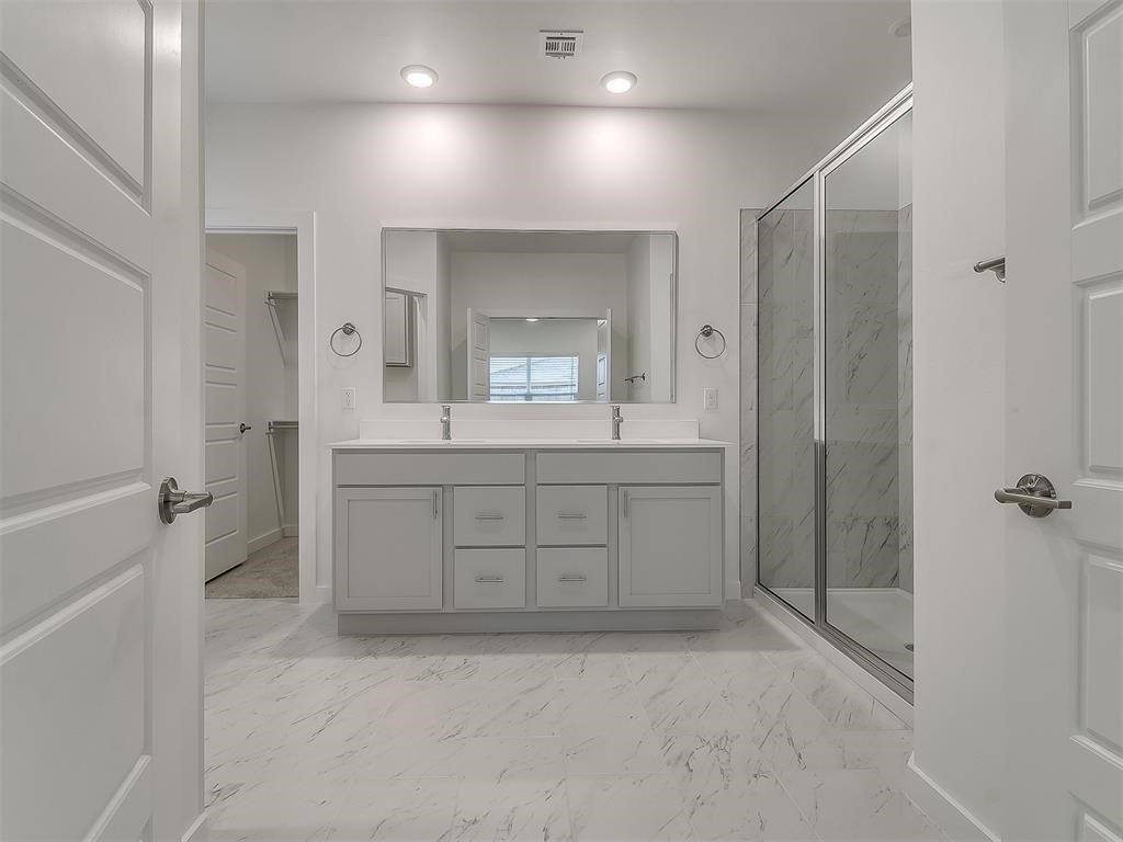 8004 NW 152nd Street, Edmond, OK 73013 bathroom with a shower with door, tile floors, and dual vanity