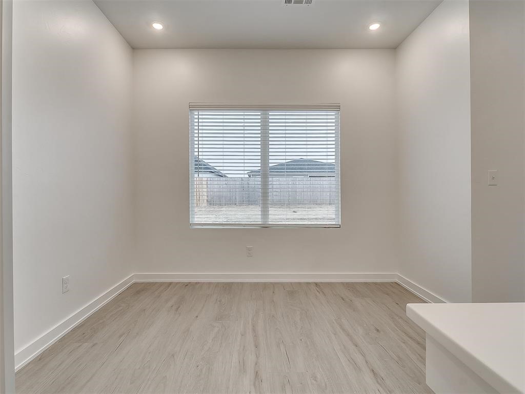 8004 NW 152nd Street, Edmond, OK 73013 empty room with light wood-type flooring