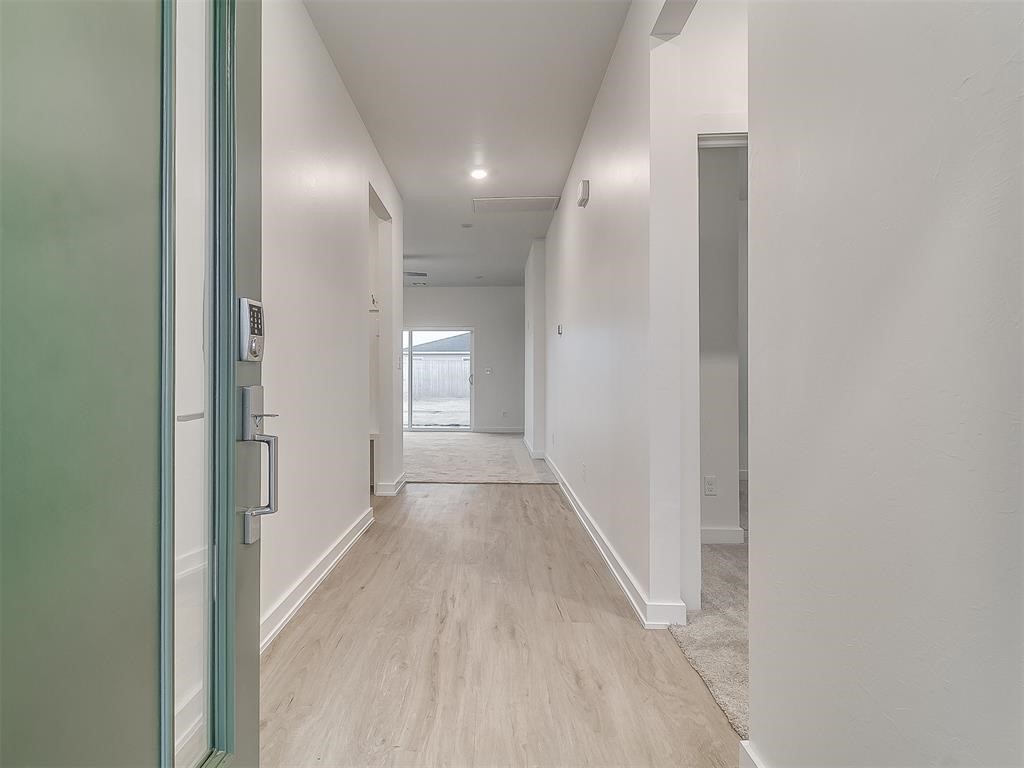 8004 NW 152nd Street, Edmond, OK 73013 hallway featuring light hardwood / wood-style floors