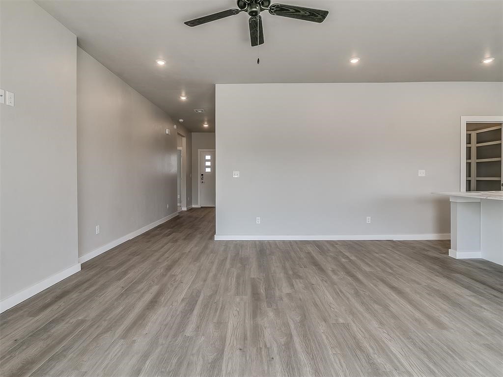 8112 NW 153rd Street, Edmond, OK 73013 empty room featuring ceiling fan and hardwood / wood-style floors