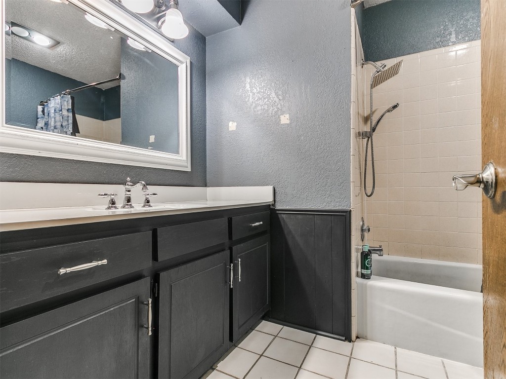 136 Sequoia Park Drive, Yukon, OK 73099 bathroom with a textured ceiling, vanity, tile floors, and shower / bathtub combination with curtain
