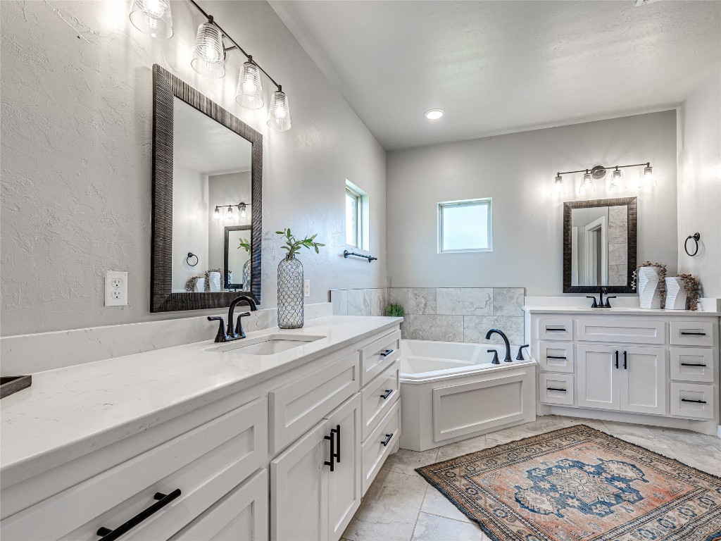 1391 S Kenzie Ct Drive, Mustang, OK 73064 bathroom featuring a tub, tile floors, and dual bowl vanity
