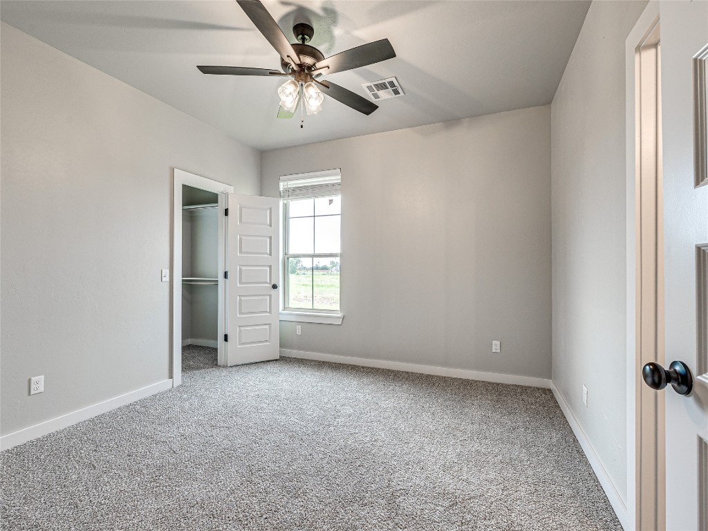 1391 S Kenzie Ct Drive, Mustang, OK 73064 unfurnished bedroom with ceiling fan and carpet floors