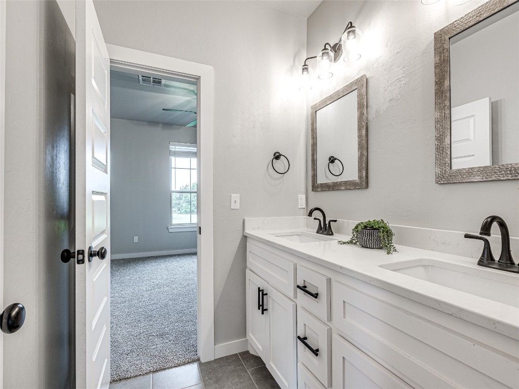 1391 S Kenzie Ct Drive, Mustang, OK 73064 bathroom featuring tile floors and dual bowl vanity