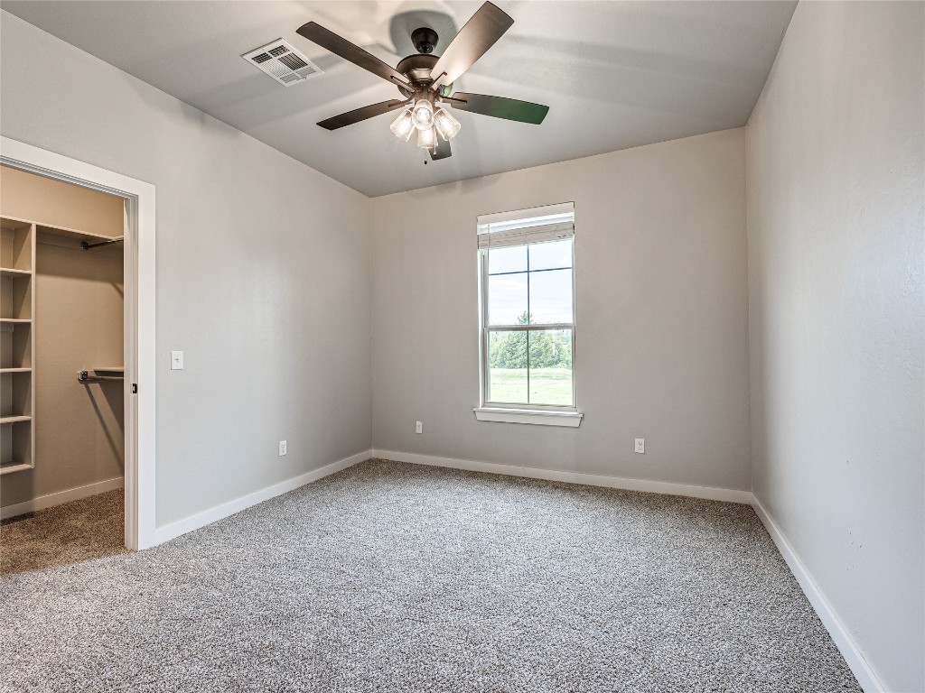1391 S Kenzie Ct Drive, Mustang, OK 73064 carpeted spare room with ceiling fan