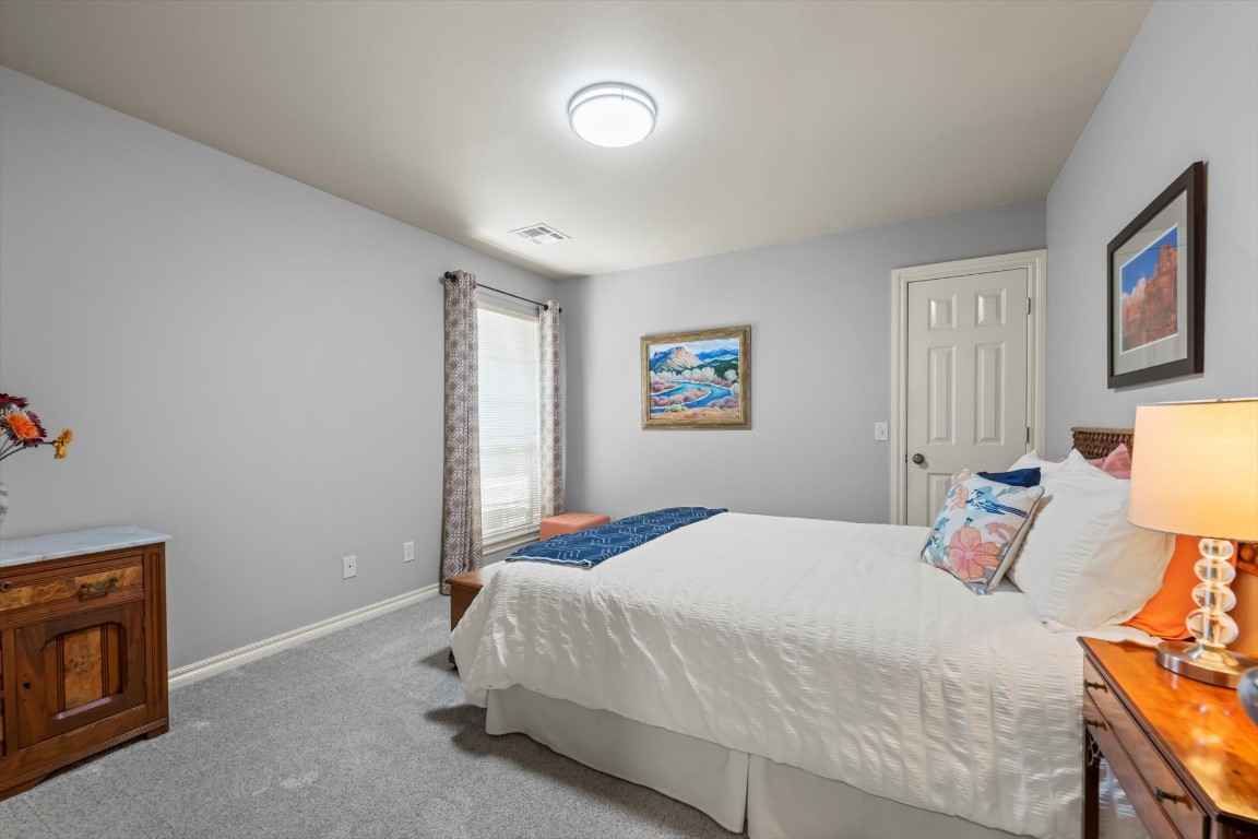 1816 Redland Drive, Edmond, OK 73003 bedroom with carpet flooring