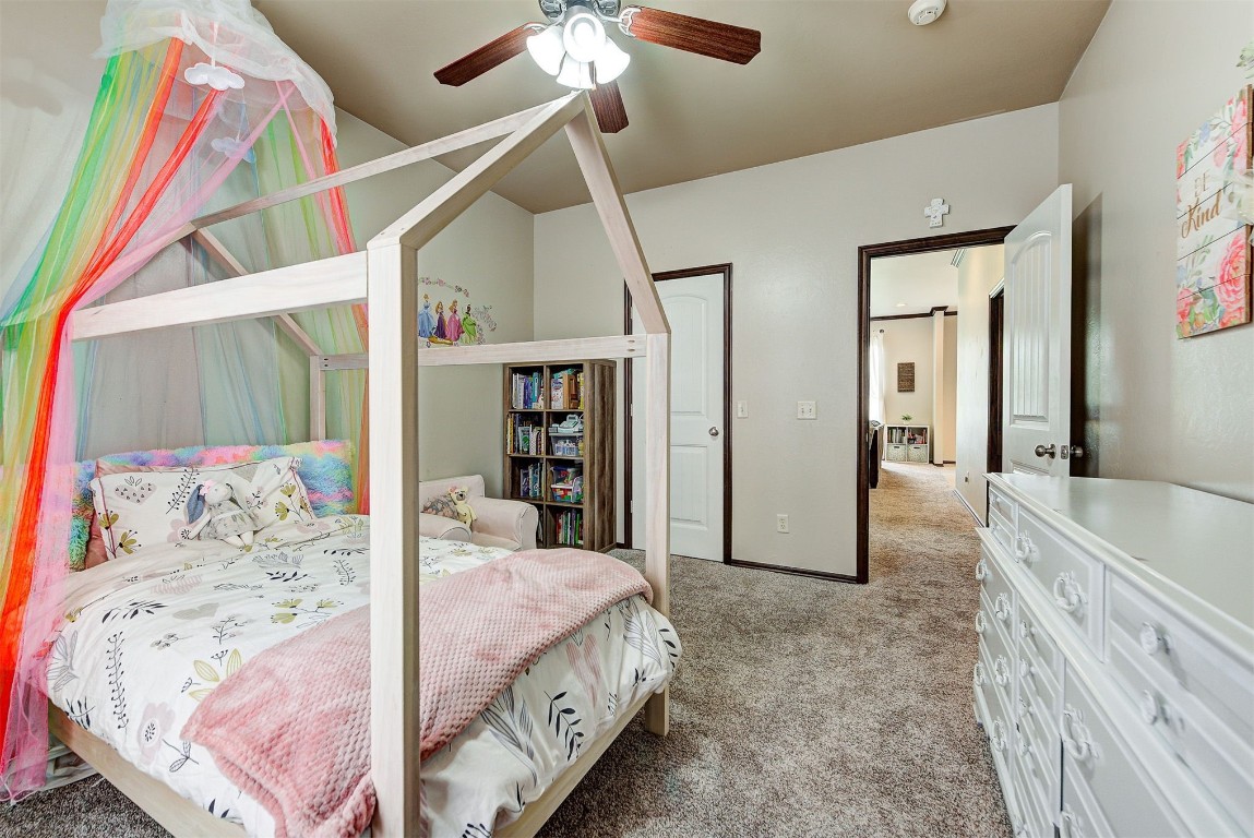 820 White Tail Court, Guthrie, OK 73044 bedroom with ceiling fan and carpet floors
